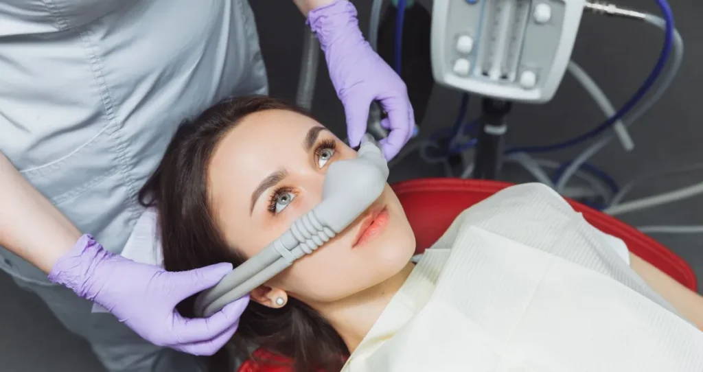 Patient receiving sedation dentistry with a nasal mask to help reduce dental anxiety