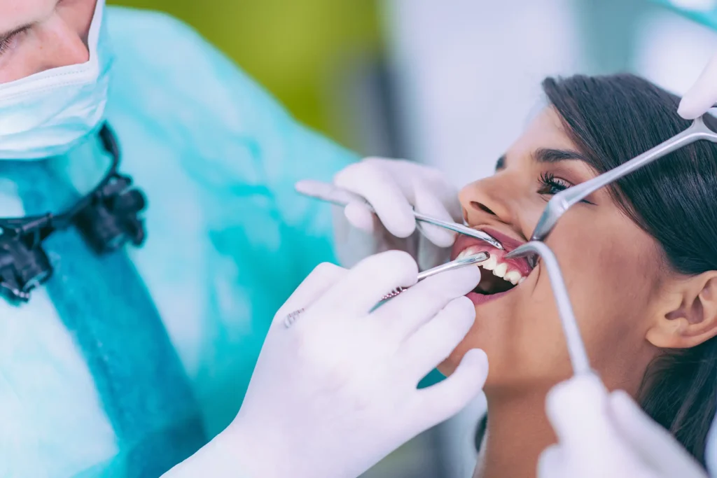 Dentist examining a patient’s teeth for preventive care to save money, time, and avoid dental problems
